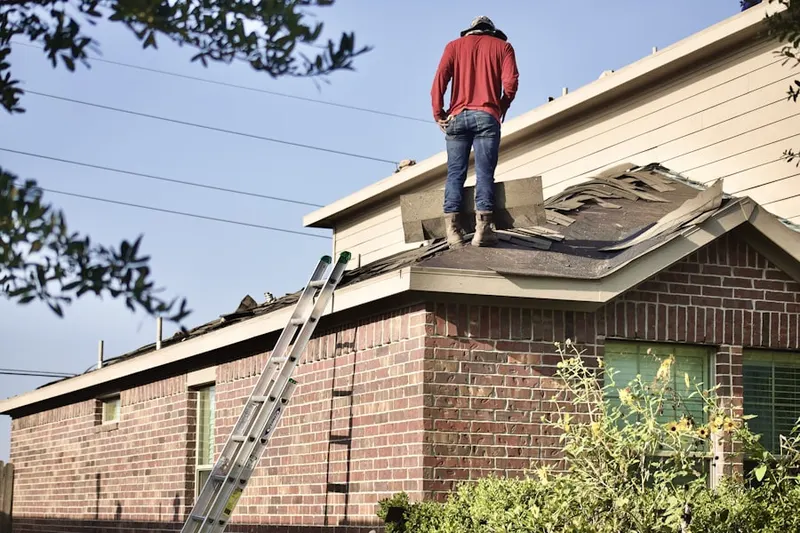 Professional roofer working on a residential roof in Davis Mill
